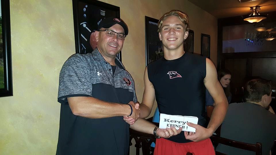 Kory Kemmerer accepts his Kerry's Krunch award from Kerry Kemmerer--his coach and dad--at Braveheart in Hellertown Friday night.