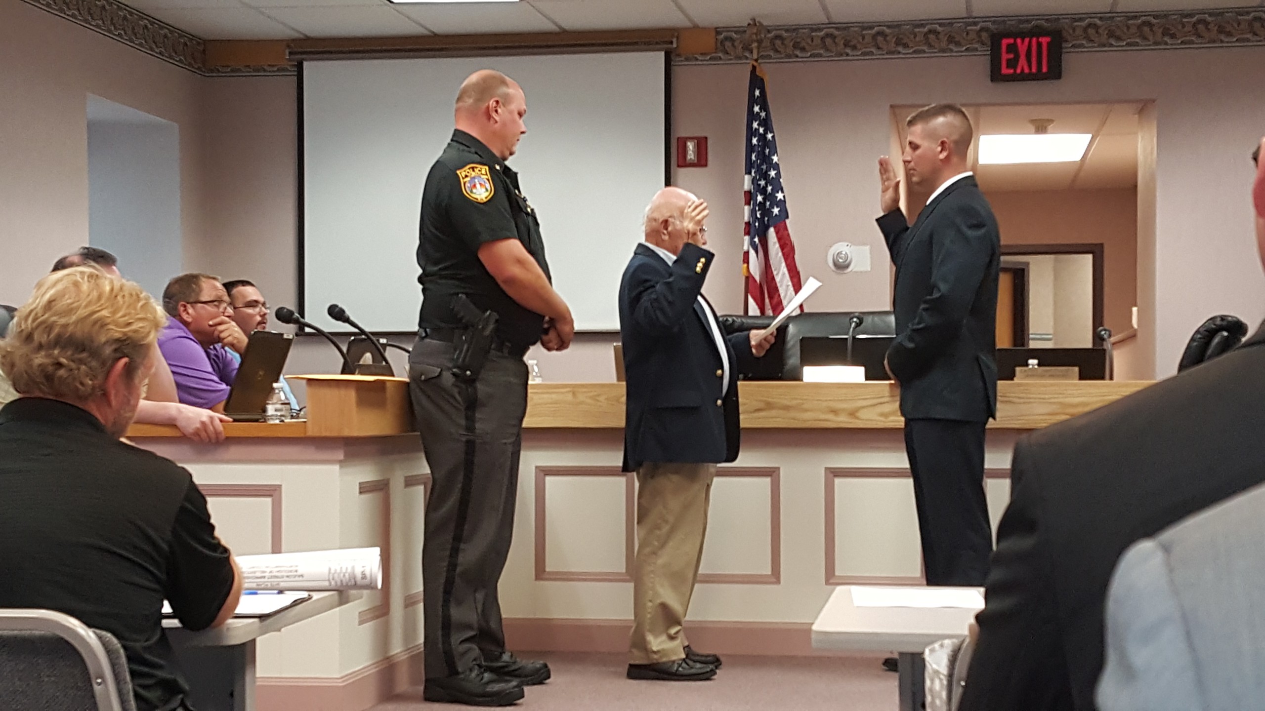 Hellertown Mayor Richard Fluck administers the oath to Ofc. Christopher Pfancook, who was promoted to full-time in the Hellertown Police Department.