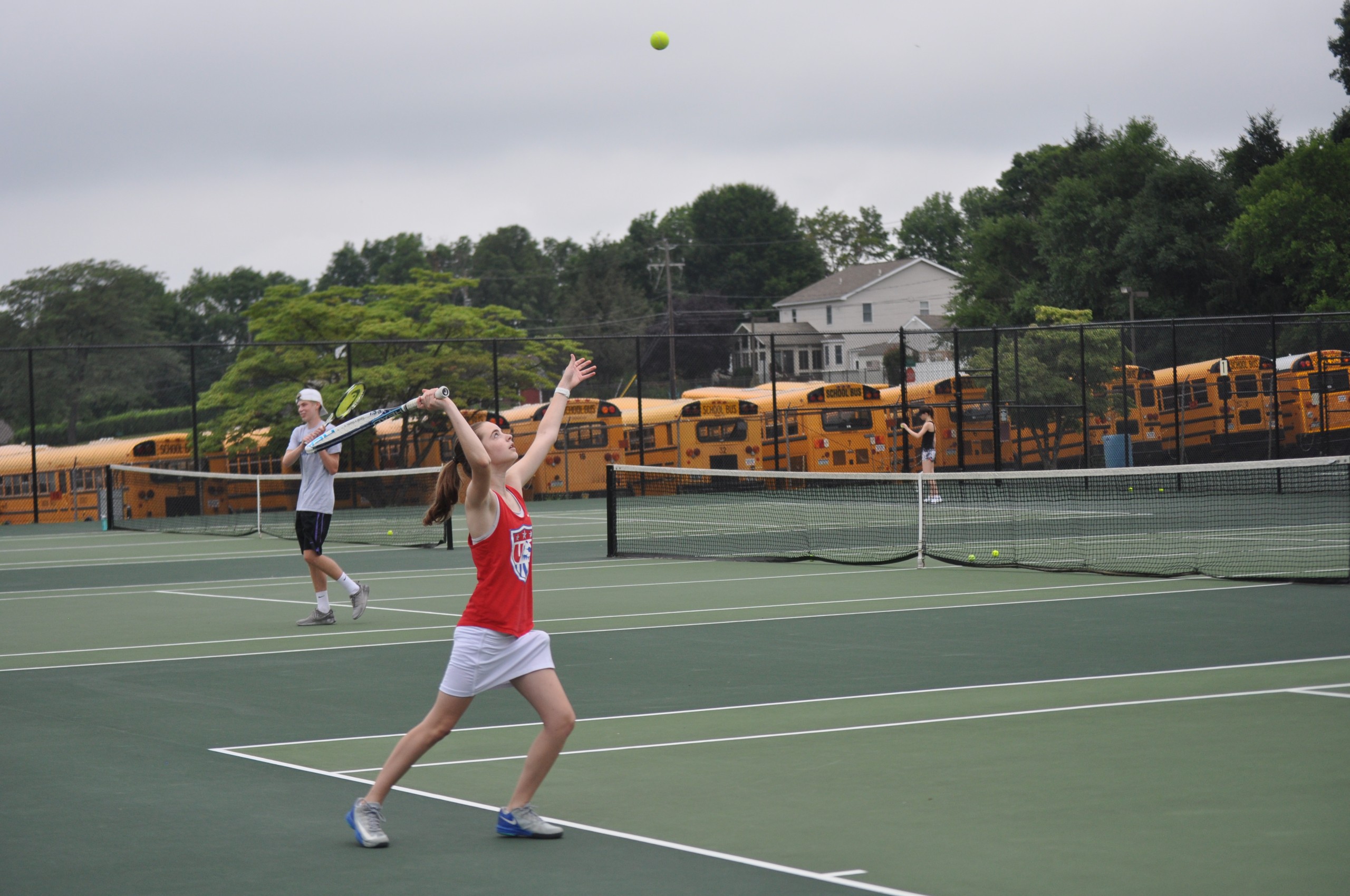 Rising sophomore Emily Ackerman works oner serve at Coach Ochse's open court.