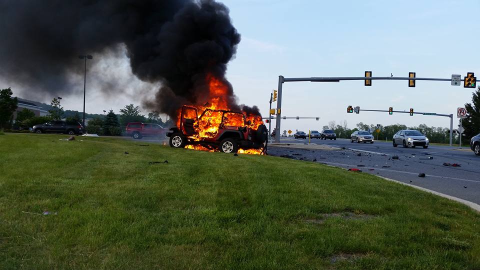 A Jeep burns near an entrance to the Promenade Shops at Saucon Valley in Upper Saucon Township following a violent accident on Center Valley Parkway Friday evening.