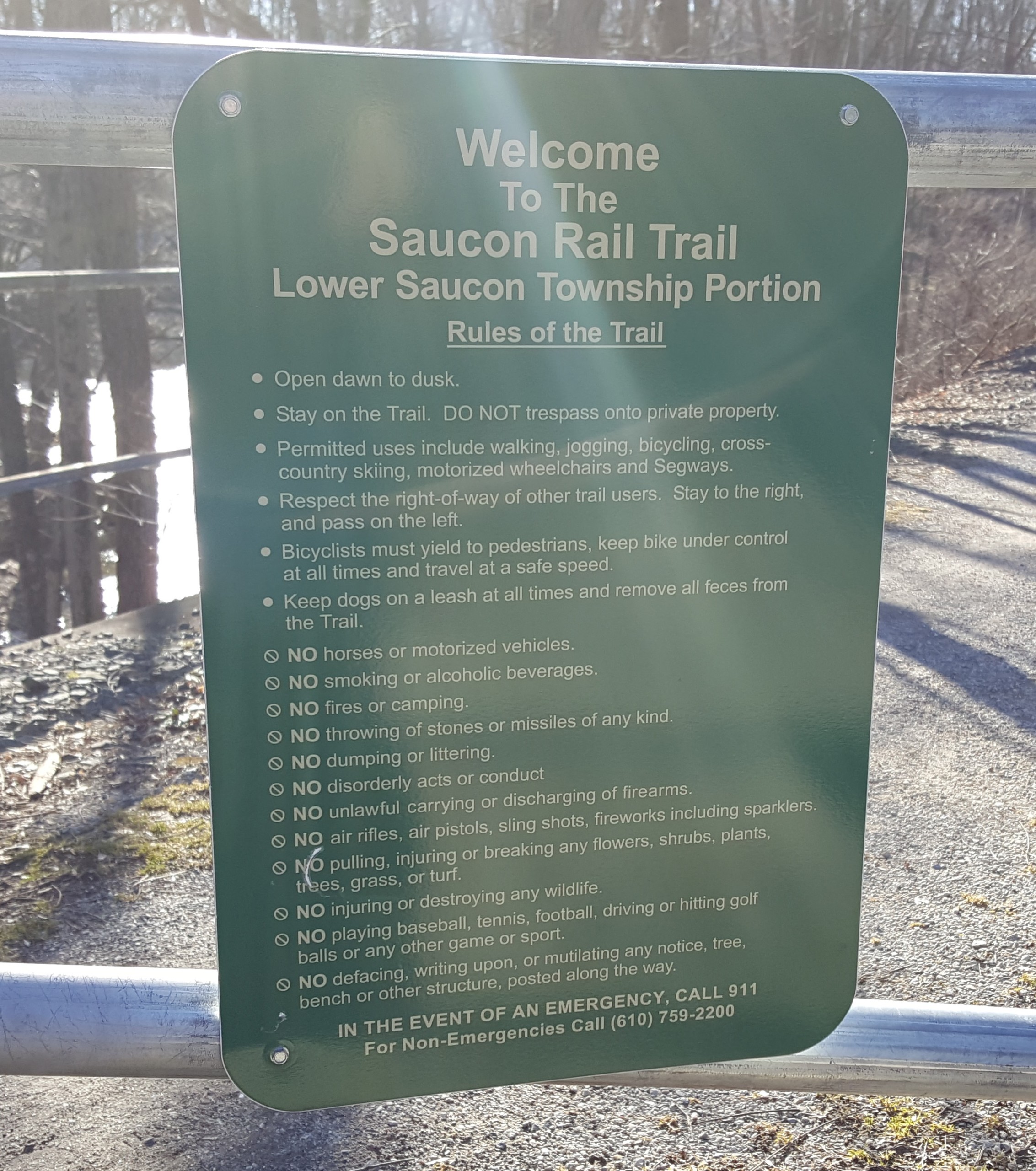 A sign enumerating the rules for trail users in Lower Saucon Township is affixed to the gate at the Old Mill Road trail crossing.