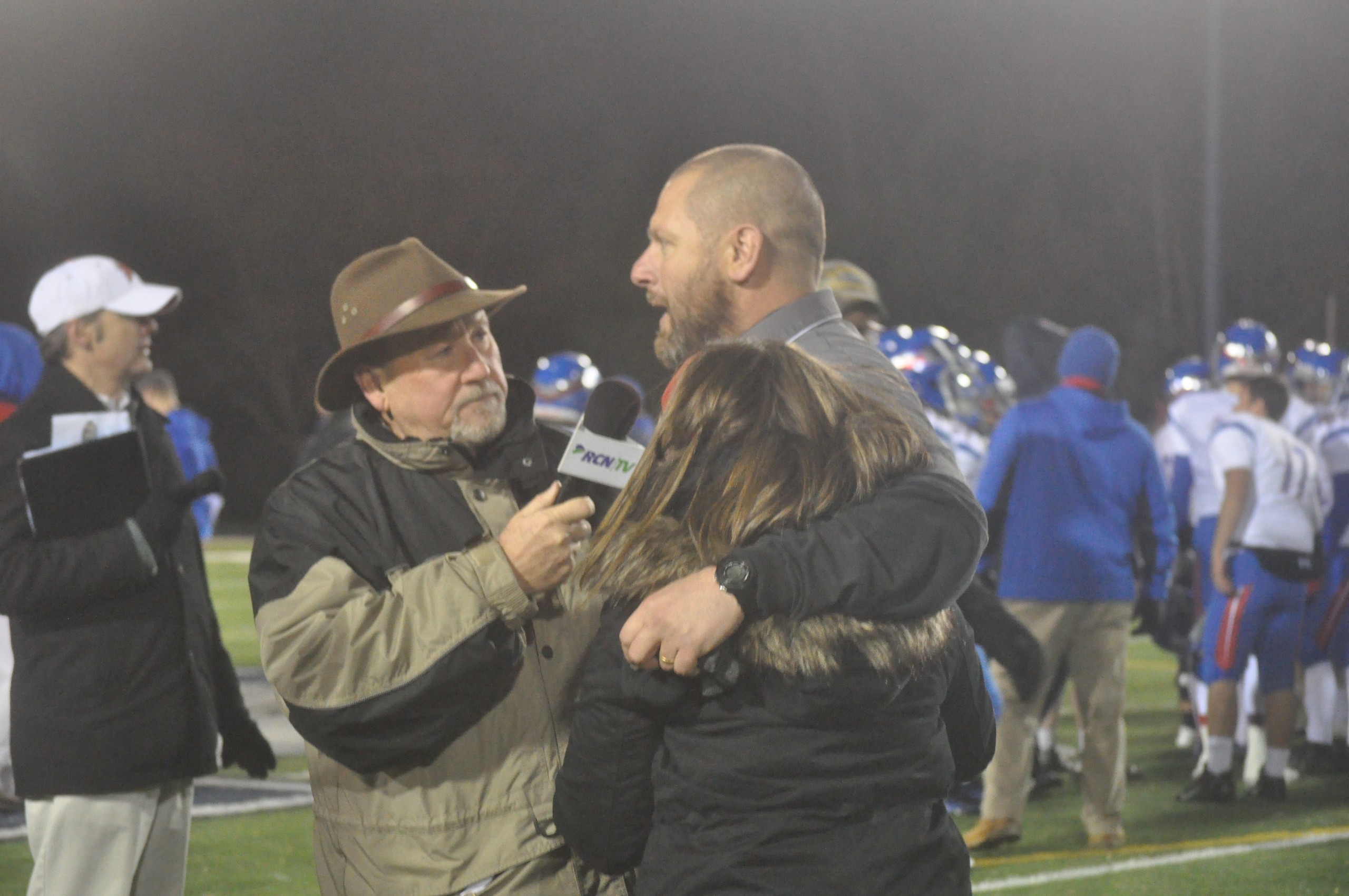 Coach Evancho gets a hug from daughter Kayla while giving an interview following the PIAA Quarterfinal win over Selinsgrove