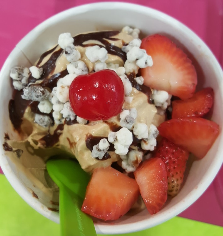 In addition to a rotating lineup of 12 different frozen yogurt flavors, YoFresh customers can choose from dozens of different toppings such as Nutella syrup, cookies-n-cream crumbles, fresh strawberries and cherries (pictured froyo flavor: salted caramel corn).