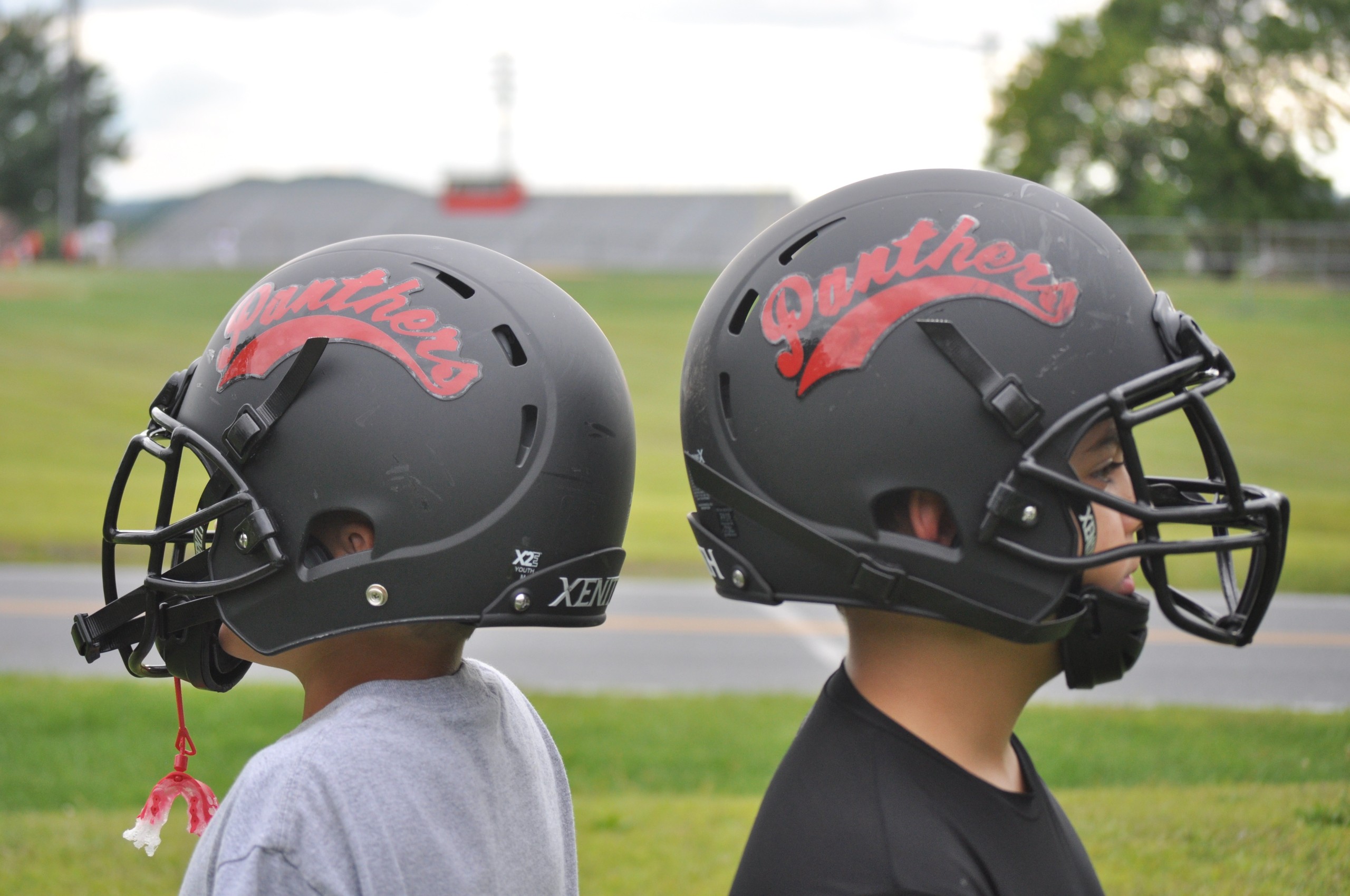 Two Saucon Valley Youth football players model their new helmets.