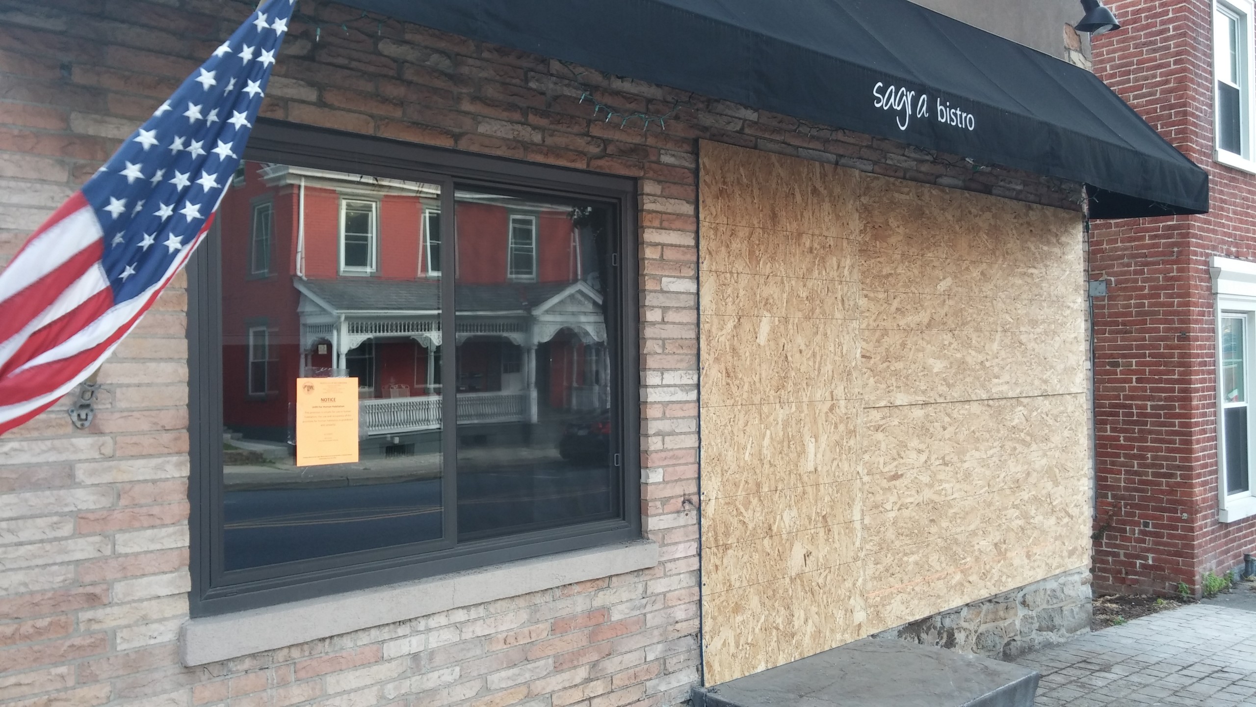 A sign posted in the front window of Sagra Bistro by Hellertown zoning and codes enforcement officer Kris Russo announces that "this premises is unsafe for use or human habitation; the use and occupancy of this premises for human habitation is prohibited and unlawful."