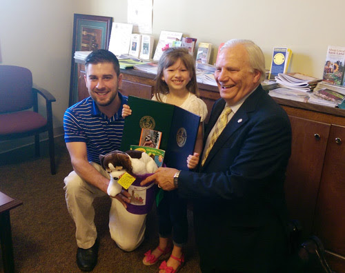 Morgan Keely, 8, receives a commendation from state Rep. Justin Simmons (left) and state Sen. Bob Mensch.