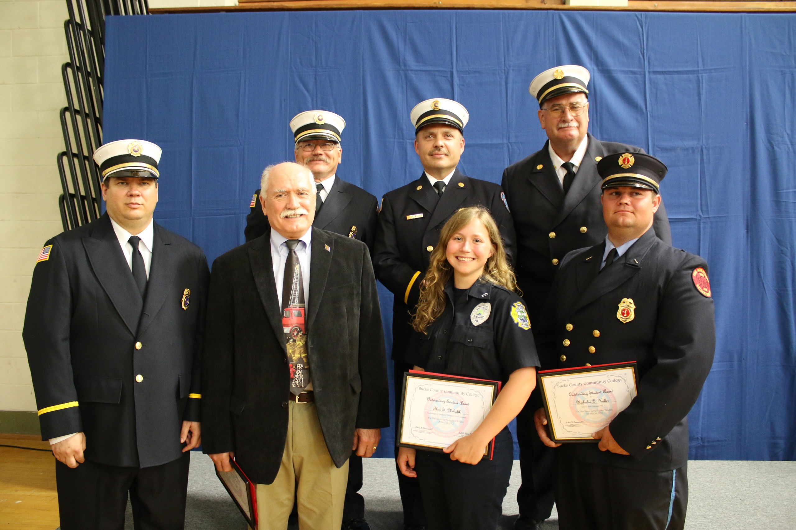 Matt Hatrak (left), director of certification and curriculum at Bucks County Community College’s Public Safety Training Center, presented Outstanding Student Awards to three firefighters who rose to the top of each class that recently completed national certification training. They are (front row, from left to right) John Wassmer of Richlandtown, Glori Mihalik of Langhorne and Nicholas Keller of Hellertown. They were joined by (back row, left to right) Fred Hashagen, director of facility operations at the PSTC, and instructors Henry Lovett and Jeff Glynn. The awards were presented during a graduation ceremony for more than 100 firefighters held Tuesday, May 19, at the college’s Newtown campus.