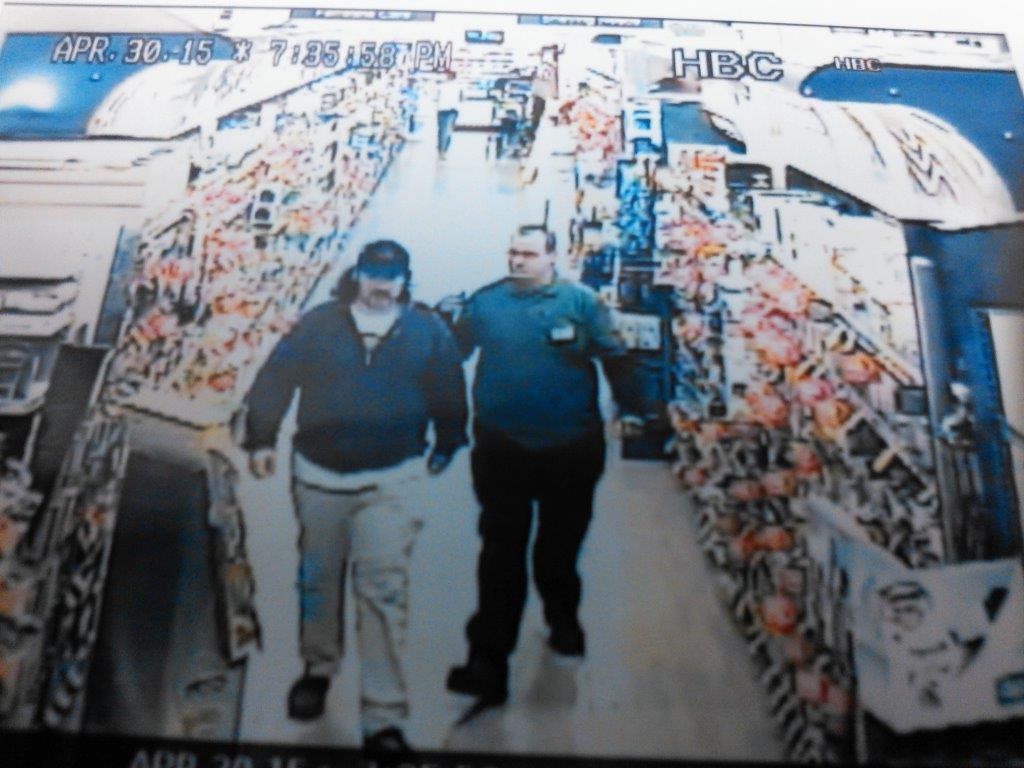 An unidentified man is escorted out of the Giant supermarket after allegedly taking photos of women in the store. Lower Saucon Township Police hope to identify him.