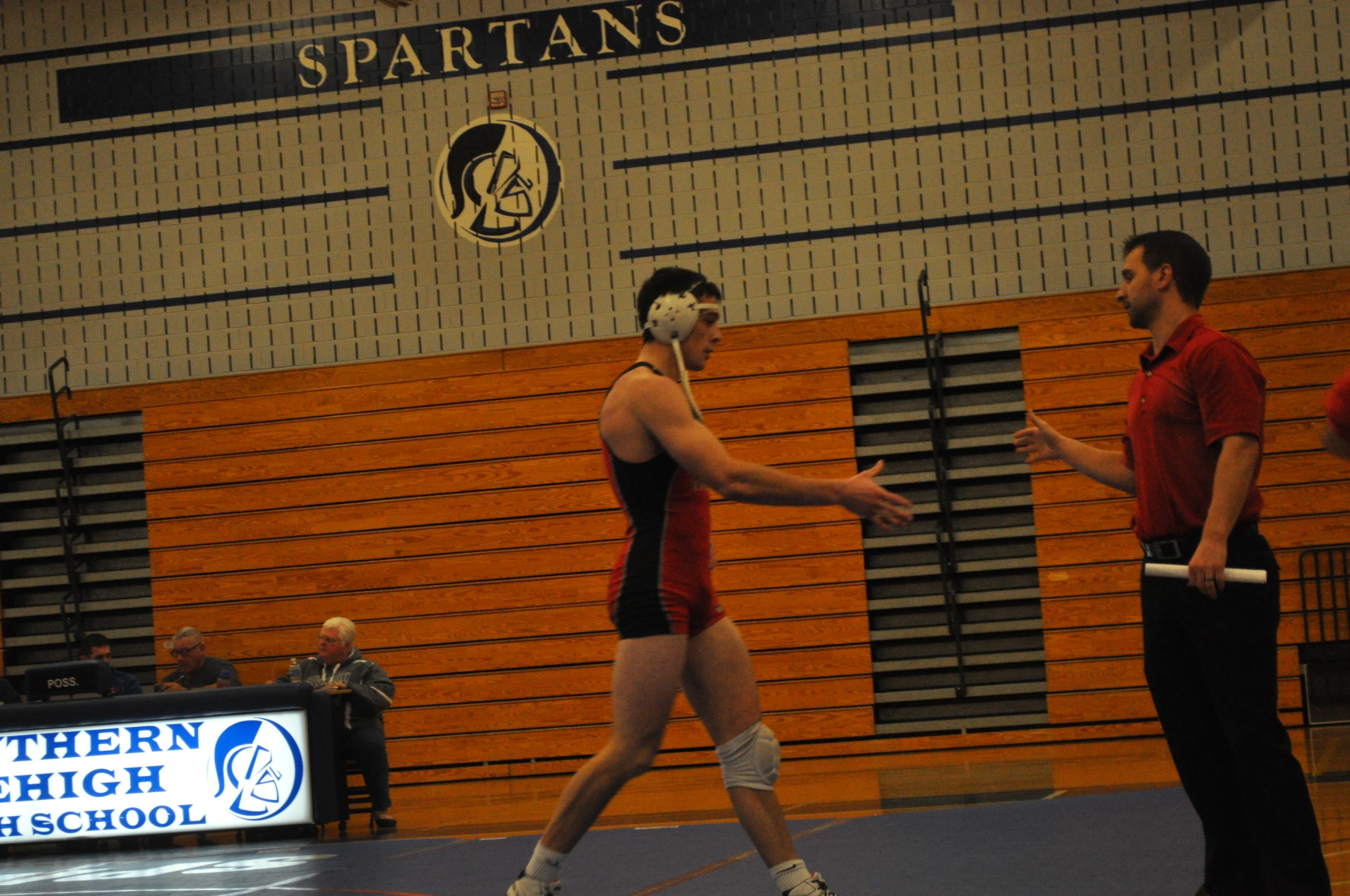 Saucon Valley wrestling coach Chad Shirk congratulates senior Jason Lynch.
