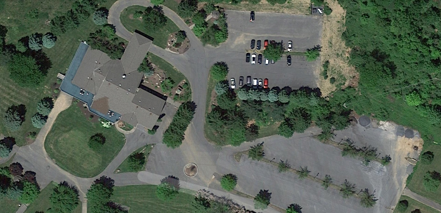 An aerial view of the main clubhouse and surrounding parking areas at the former Woodland Hills Golf Course in Lower Saucon Township.