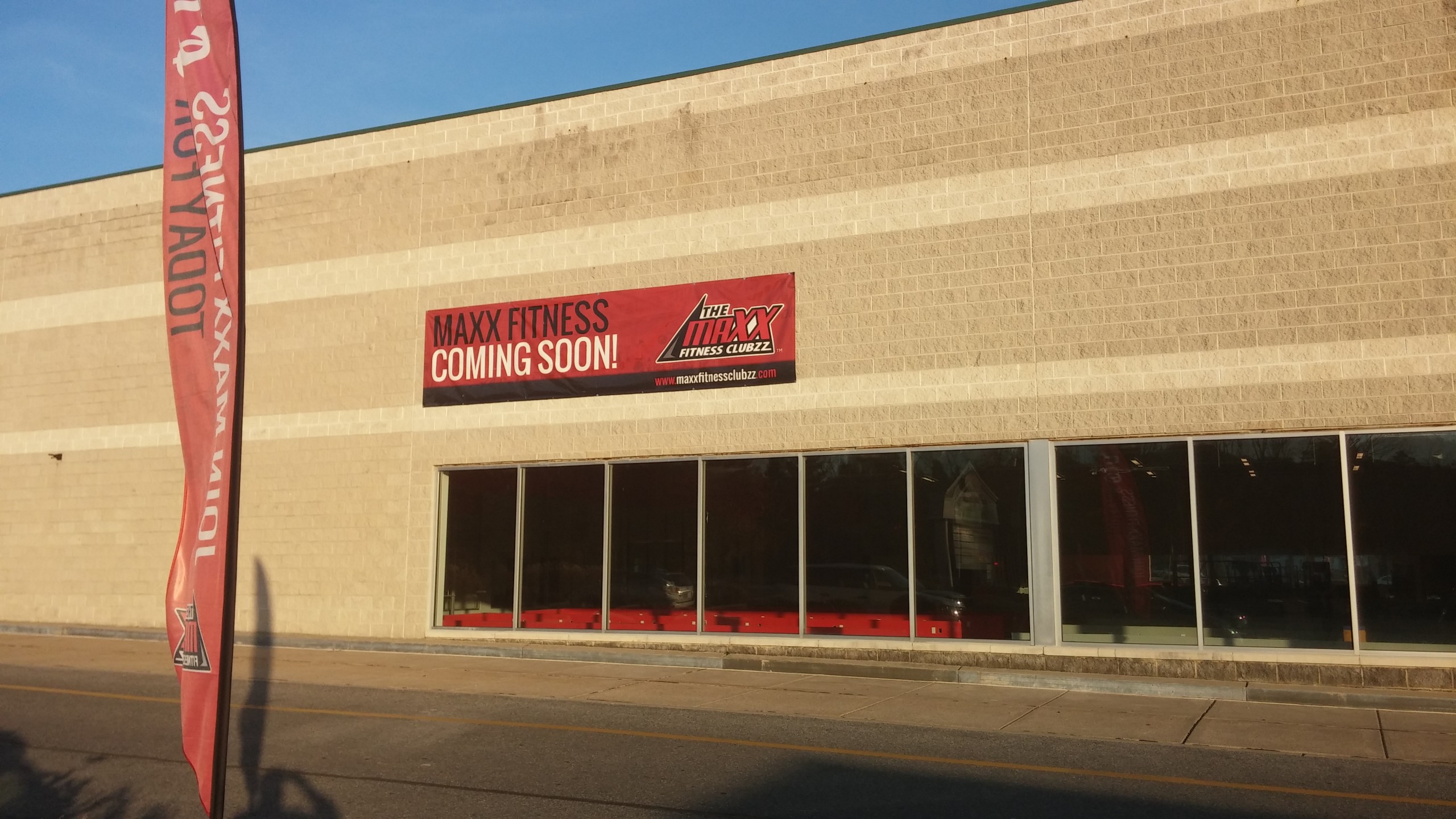 A banner on the outside of the building announces the imminent opening of Maxx Fitness, a new gym in the Saucon Square shopping center in Lower Saucon Township.